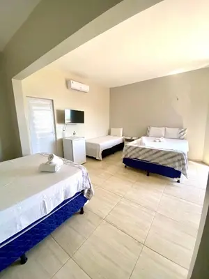 Uma cama ou camas num quarto em Praieiro pousada