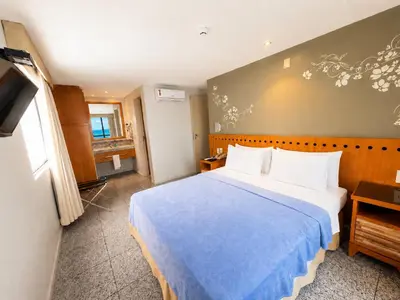 Uma cama ou camas num quarto em Hosts BR - Flat de Frente para o Mar na Beira Mar