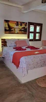 Uma cama ou camas num quarto em Pousada Lotus
