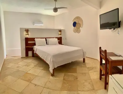 Uma cama ou camas num quarto em Pousada Borboleta