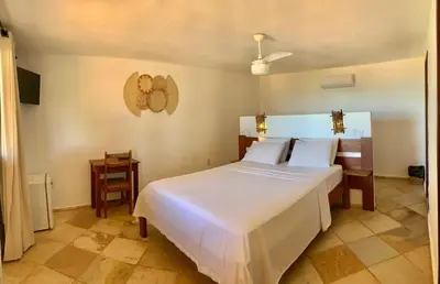 Uma cama ou camas num quarto em Pousada Borboleta