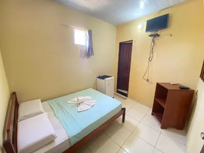 Uma cama ou camas num quarto em Pousada do Ary