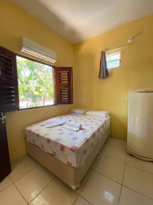 Uma cama ou camas num quarto em Pousada do Ary