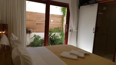 Uma cama ou camas num quarto em Suítes Jardins de Flecheiras