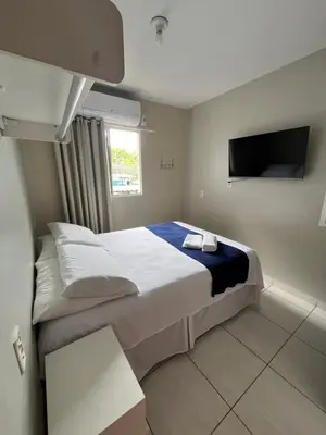 Uma cama ou camas num quarto em Teto Hospedagens