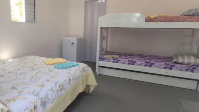 Uma cama ou camas num quarto em Aconchego da Nina