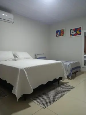 Uma cama ou camas num quarto em Pousada Villa Manduca