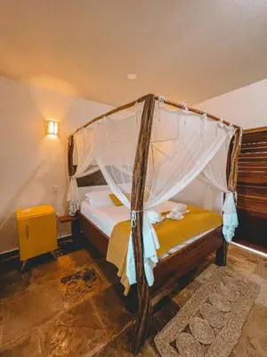 Uma cama ou camas num quarto em Pousada Fortal Preá