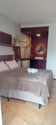 Uma cama ou camas num quarto em Pousada Flor de Lena- Lotus