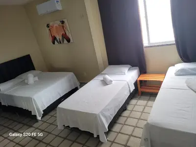 Uma cama ou camas num quarto em Pousada Temporada Atlântica
