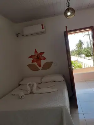 Uma cama ou camas num quarto em Pousada Recanto das Flores