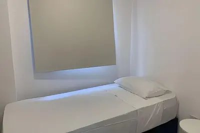 Uma cama ou camas num quarto em Hosts BR - Apartamentos funcionais