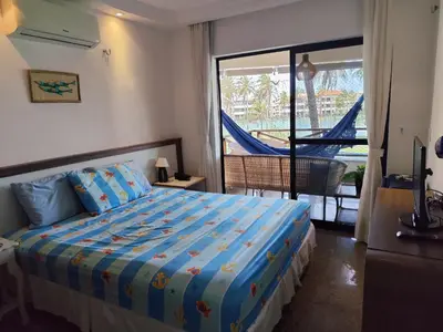Uma cama ou camas num quarto em Apartamento Aquaville Pé na areia e Água coco