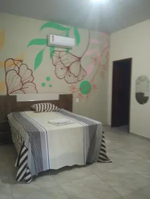Uma cama ou camas num quarto em Vila São Miguel