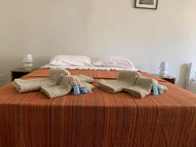 Uma cama ou camas num quarto em Casa do Sol Fortaleza