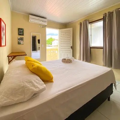 Uma cama ou camas num quarto em Encanto do Sol Hospedagem