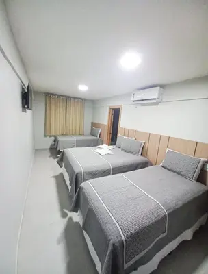 Uma cama ou camas num quarto em HOTEL KICHARME PONTAL