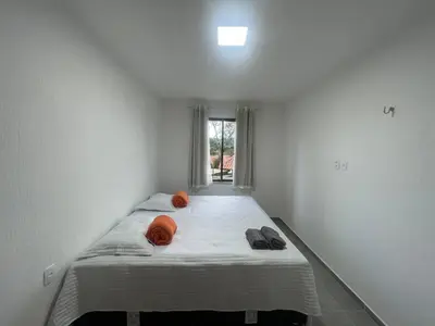 Uma cama ou camas num quarto em Casa em Condomínio Montserrat