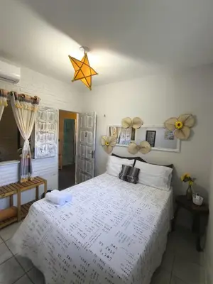 Uma cama ou camas num quarto em Hospedaria Mandacaru
