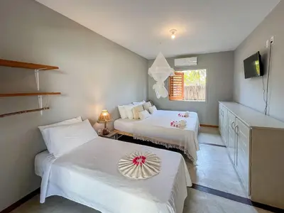 Uma cama ou camas num quarto em Casa super charmosa com piscina em Icaraizinho!
