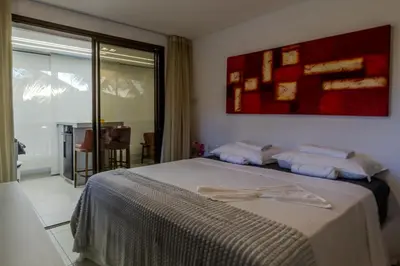 Uma cama ou camas num quarto em Mandara Lanai Apartamento Bangalô