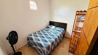 Uma cama ou camas num quarto em Localize casa na praia