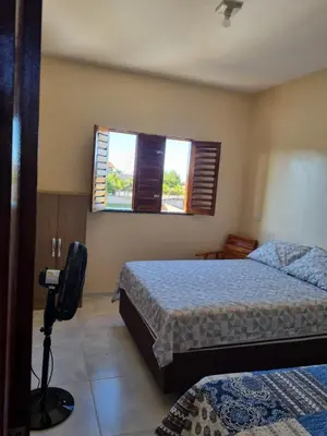Uma cama ou camas num quarto em Duplex de 2 quartos com ar condicionado , piscina e estacionamento
