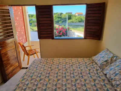 Uma cama ou camas num quarto em Duplex de 2 quartos com ar condicionado , piscina e estacionamento