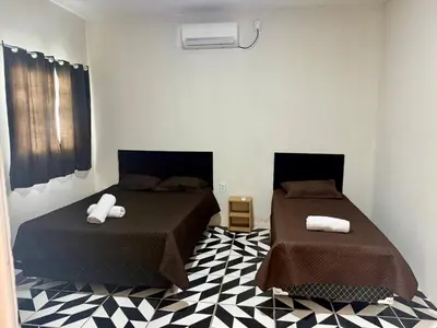 Uma cama ou camas num quarto em Casa no centro na Praia do Preá/CE