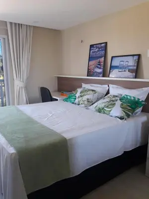 Uma cama ou camas num quarto em Porto das Dunas Solarium Residence