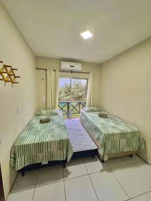Uma cama ou camas num quarto em Residencial Nova Taíba CE com vista para o mar