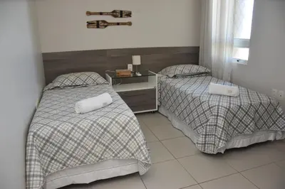 Uma cama ou camas num quarto em TERRAMARIS DUPLEX LUXO - FRENTE MAR