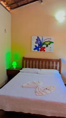 Uma cama ou camas num quarto em Pousada Paraíso das Falésias