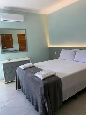 Uma cama ou camas num quarto em Pousada Maanain