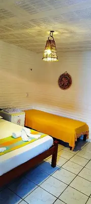 Uma cama ou camas num quarto em Pousada Roane - Taíba