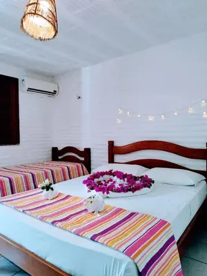 Uma cama ou camas num quarto em Pousada Roane - Taíba