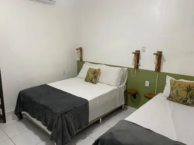 Uma cama ou camas num quarto em Villa Encantos do Paraíso 50mts da lagoa