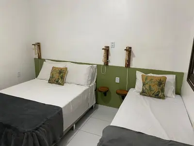 Uma cama ou camas num quarto em Villa Encantos do Paraíso 50mts da lagoa