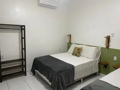 Uma cama ou camas num quarto em Villa Encantos do Paraíso 50mts da lagoa