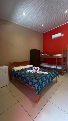 Uma cama ou camas num quarto em Pousada Rio e Mar
