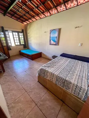 Uma cama ou camas num quarto em Casa Rústica em Morro Branco - na quadra da praia