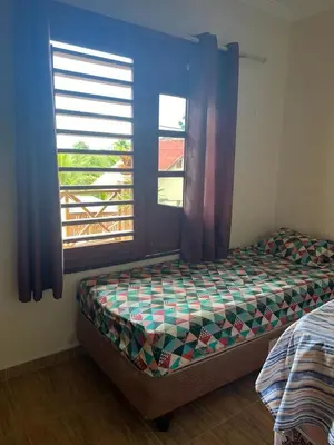 Uma cama ou camas num quarto em Chalé Guaramiranga-CE