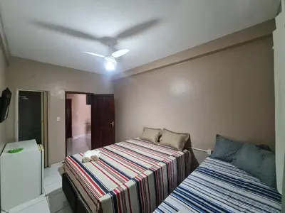 Uma cama ou camas num quarto em Pousada Meireles Praia