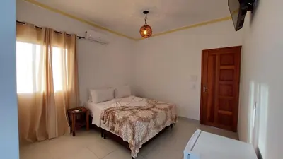 Uma cama ou camas num quarto em Pousada Albuquerque