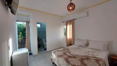 Uma cama ou camas num quarto em Pousada Albuquerque