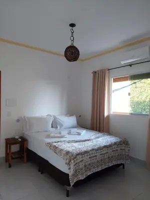 Uma cama ou camas num quarto em Pousada Albuquerque