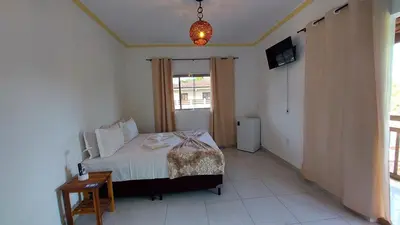 Uma cama ou camas num quarto em Pousada Albuquerque
