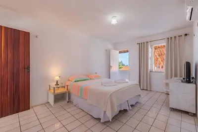 Uma cama ou camas num quarto em Casa em Porto das Dunas por Carpediem