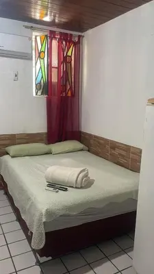 Uma cama ou camas num quarto em Pousada Carimbó