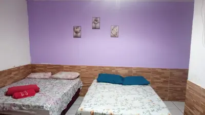 Uma cama ou camas num quarto em Pousada Carimbó